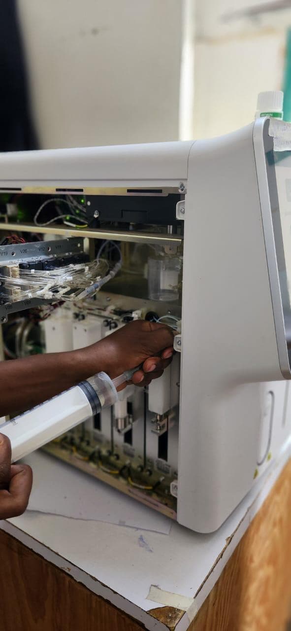 Biomedical technician servicing the internal components of diagnostic equipment